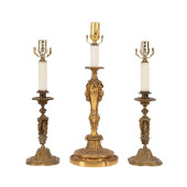 THREE GILT BRONZE CANDLESTICKS