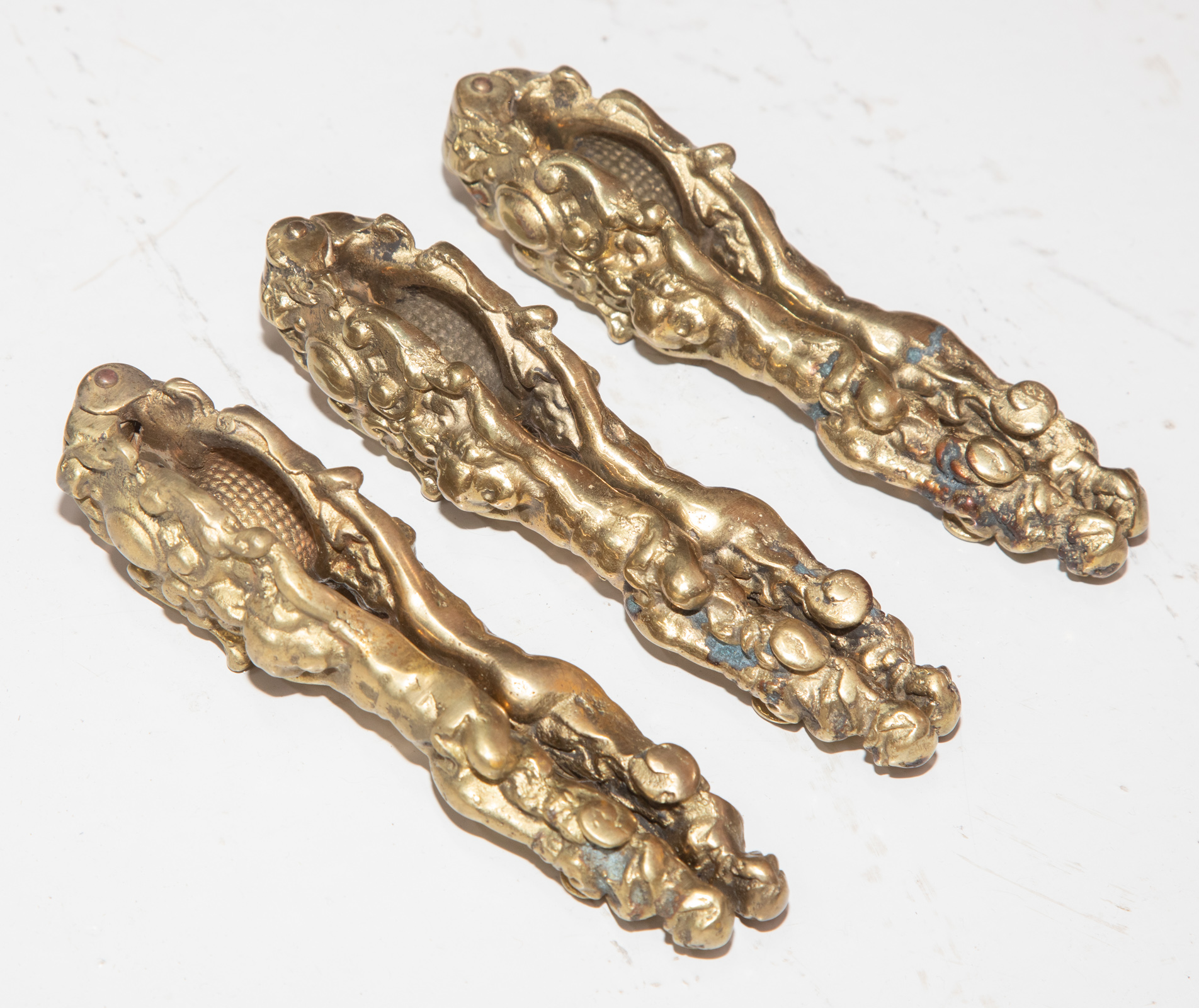 THREE GILT-BRONZE NUTCRACKERS
