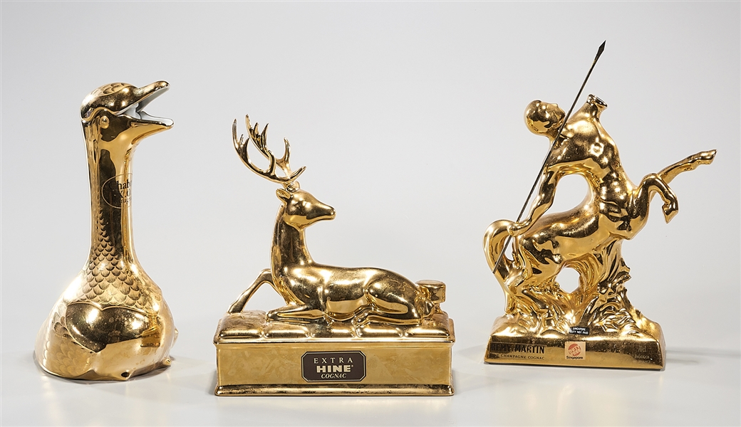 Three gilt porcelain decanters of
