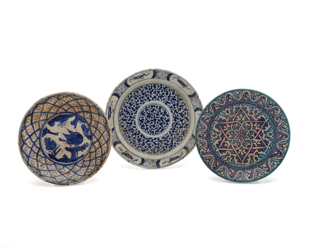 THREE GLAZED POTTERY PLATESThree
