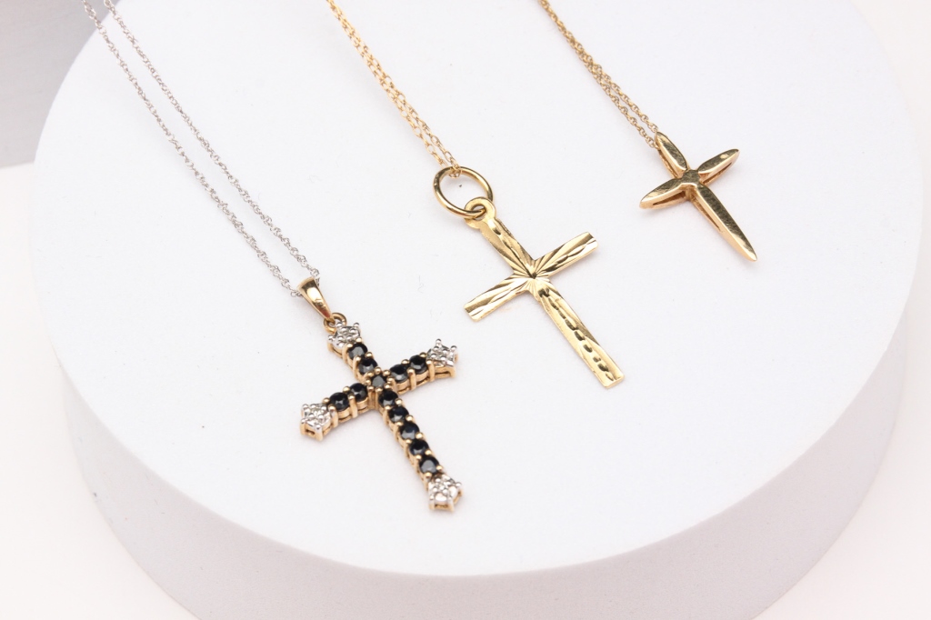 THREE GOLD CROSS PENDANTS.