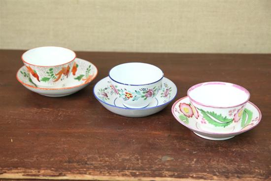 THREE HANDELESS CUPS AND SAUCERS.