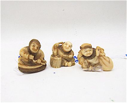 THREE IVORY CARVED NETSUKE FIGURES: