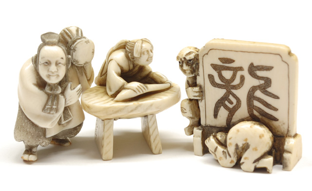 THREE IVORY CARVED NETSUKE: one man
