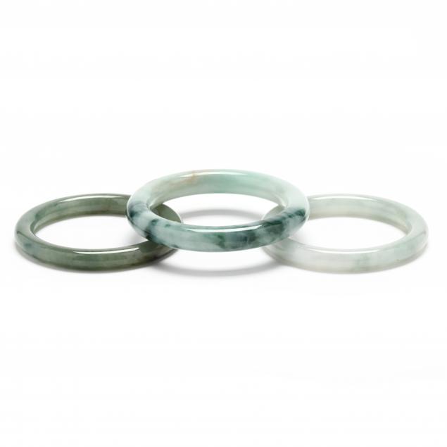 THREE JADE BANGLES To include: a