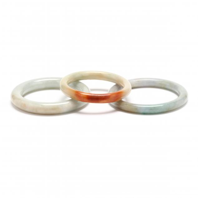 THREE JADE BANGLES To include: a