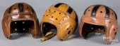 THREE LEATHER FOOTBALL HELMETS