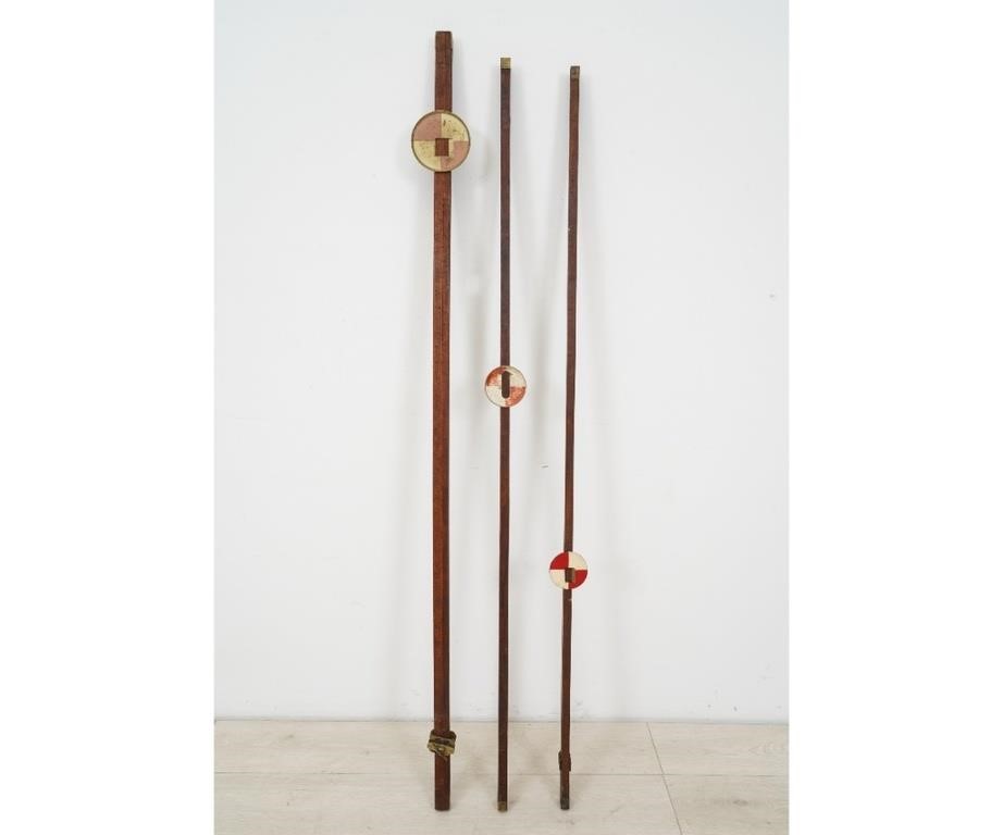 Three leveling rods, one missing