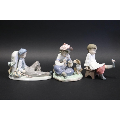 Three Lladro figures of boys,