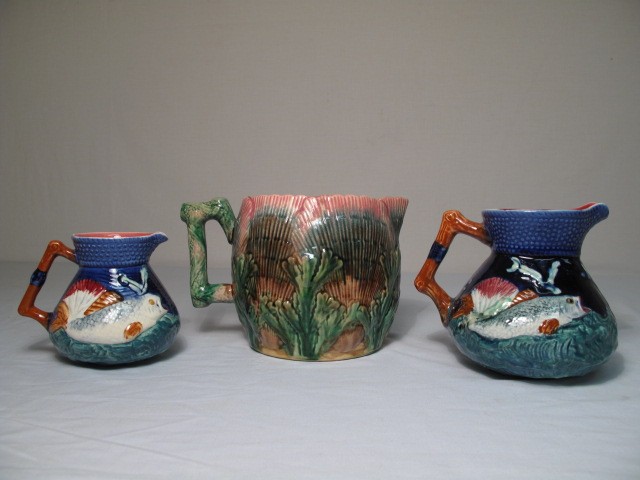 Three Majolica pottery pitchers.