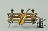 THREE MUSICIANS SEATED ON BENC