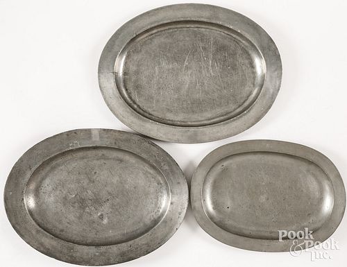 THREE OVAL PEWTER PLATTERS,