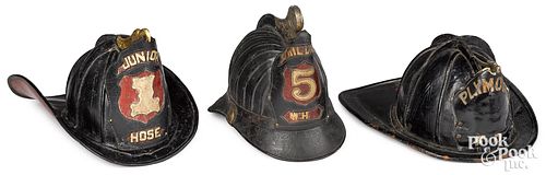 THREE PAINTED LEATHER FIRE HELMETS,