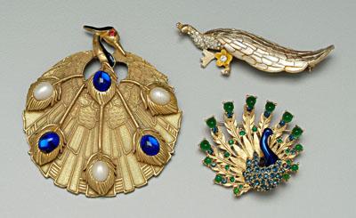 Three peacock costume brooches: one