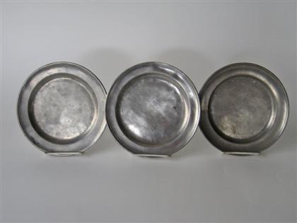 Three pewter plates with molded rim