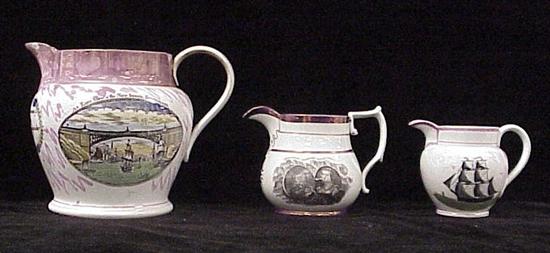 Three pitchers with pink luster