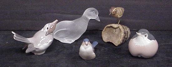 Three porcelain and one glass birds