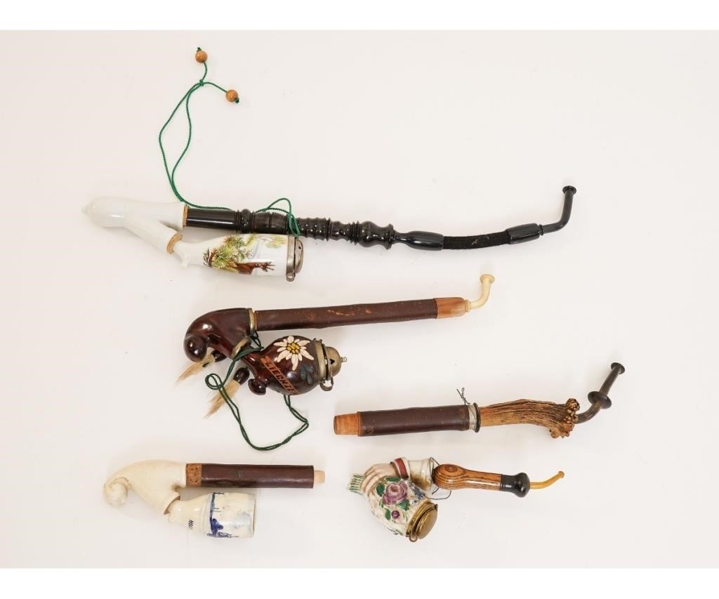 Three porcelain/wood pipes, one