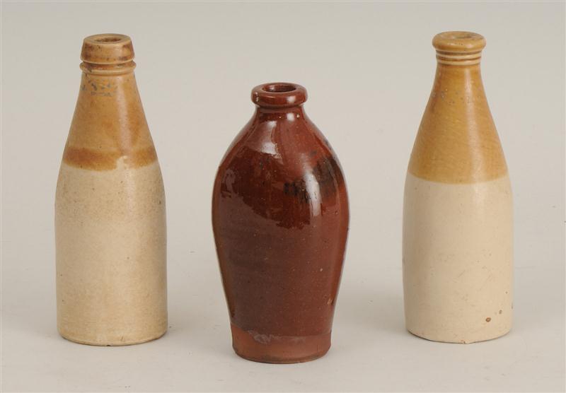 THREE POTTERY BOTTLES In brown or