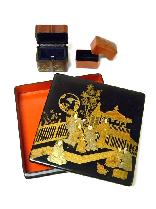 Three red and black lacquered boxes