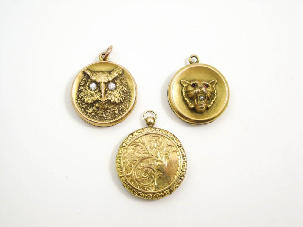 THREE ROUND GOLD PENDANT LOCKETS: