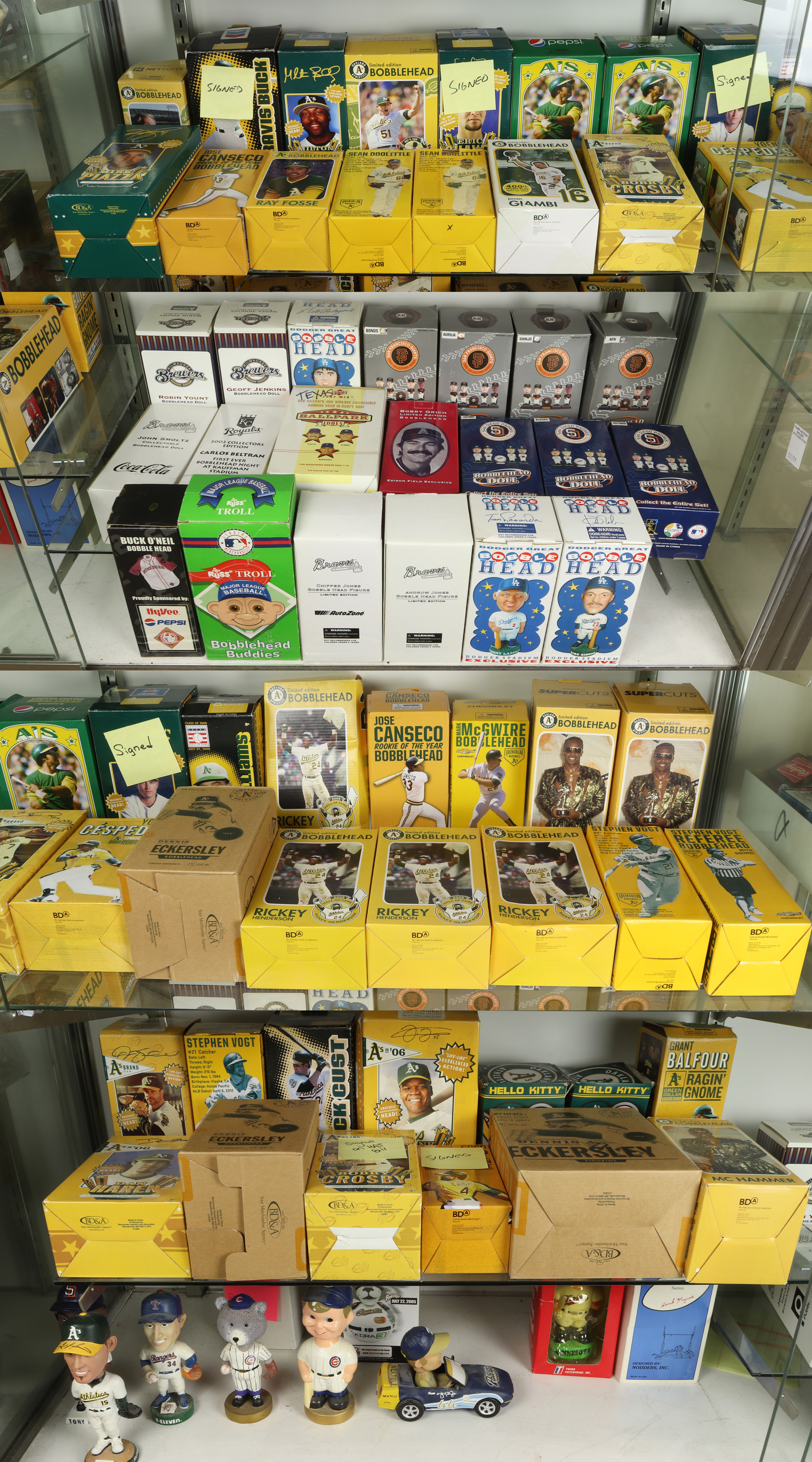 THREE SHELVES OF BOBBLE HEADS Three