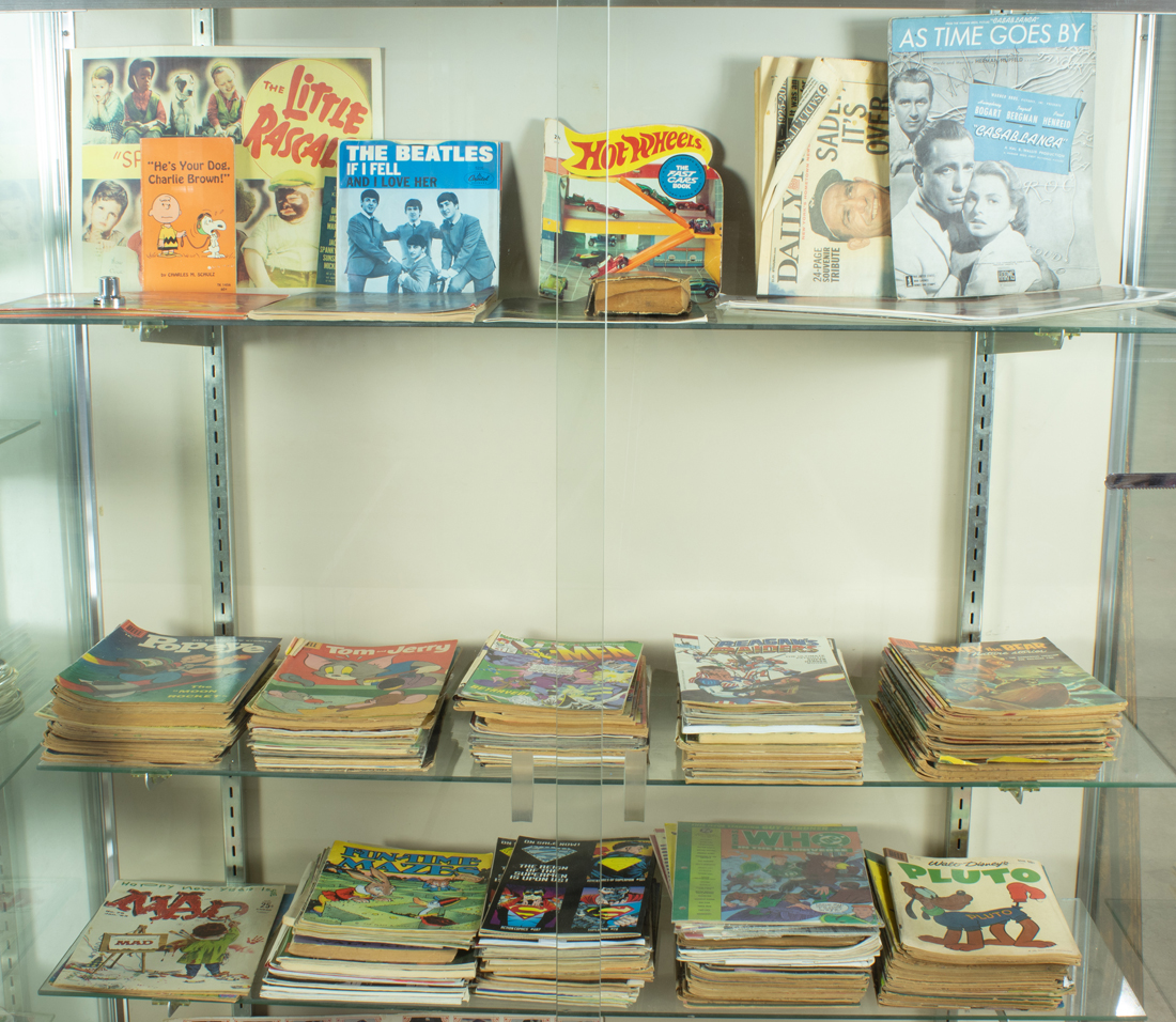 THREE SHELVES OF COMICS Three
