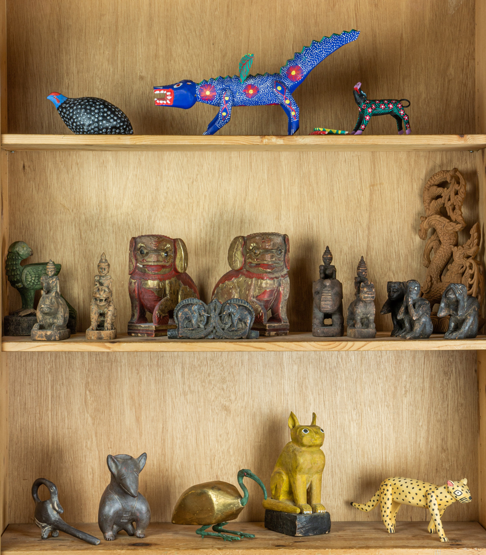 THREE SHELVES OF ETHNIC WOOD