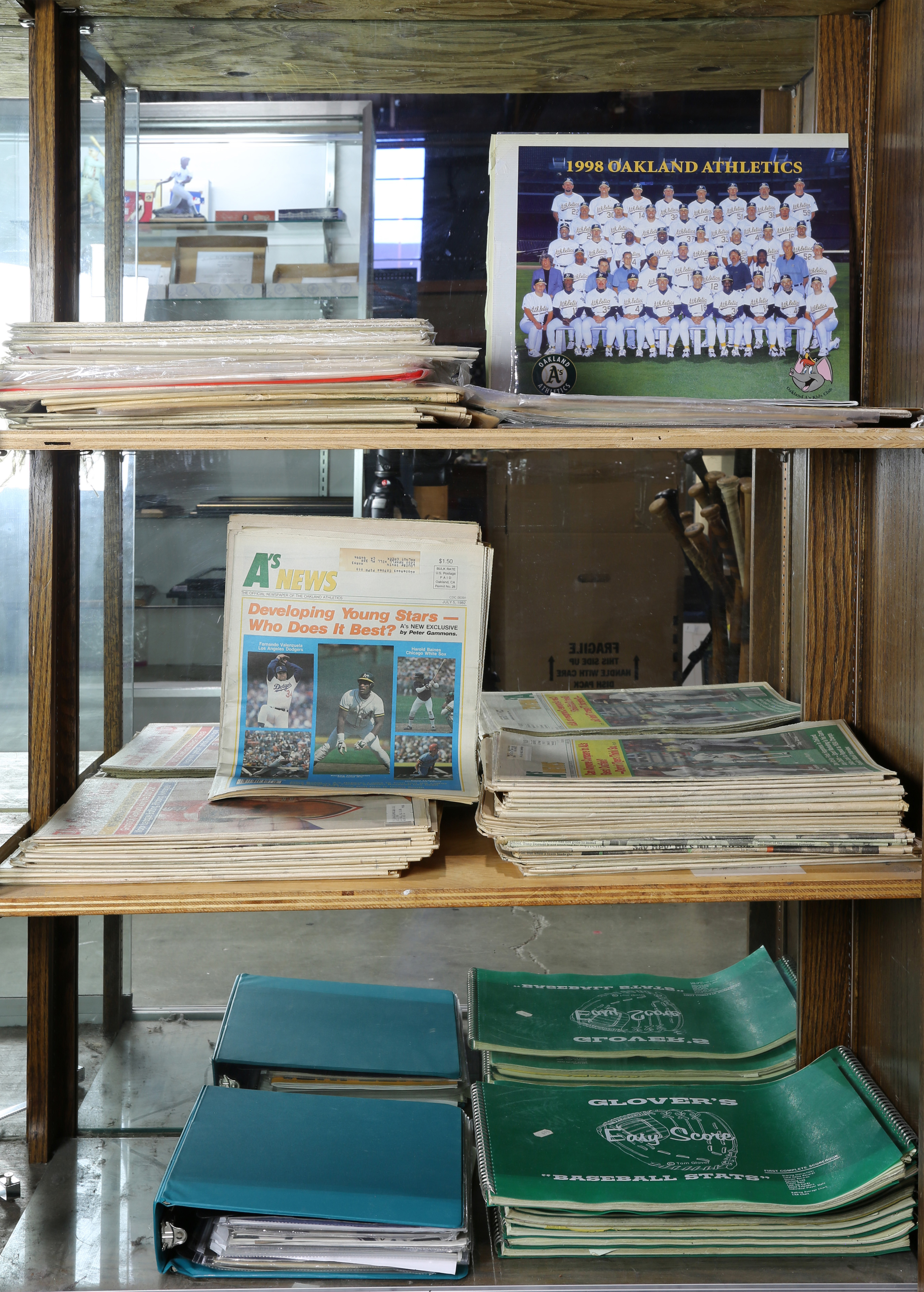 THREE SHELVES OF NEWSPAPERS