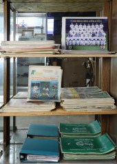 THREE SHELVES OF NEWSPAPERS IN
