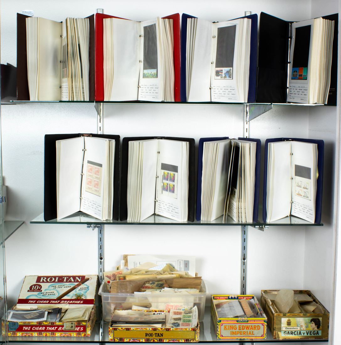 THREE SHELVES OF STAMPS Three
