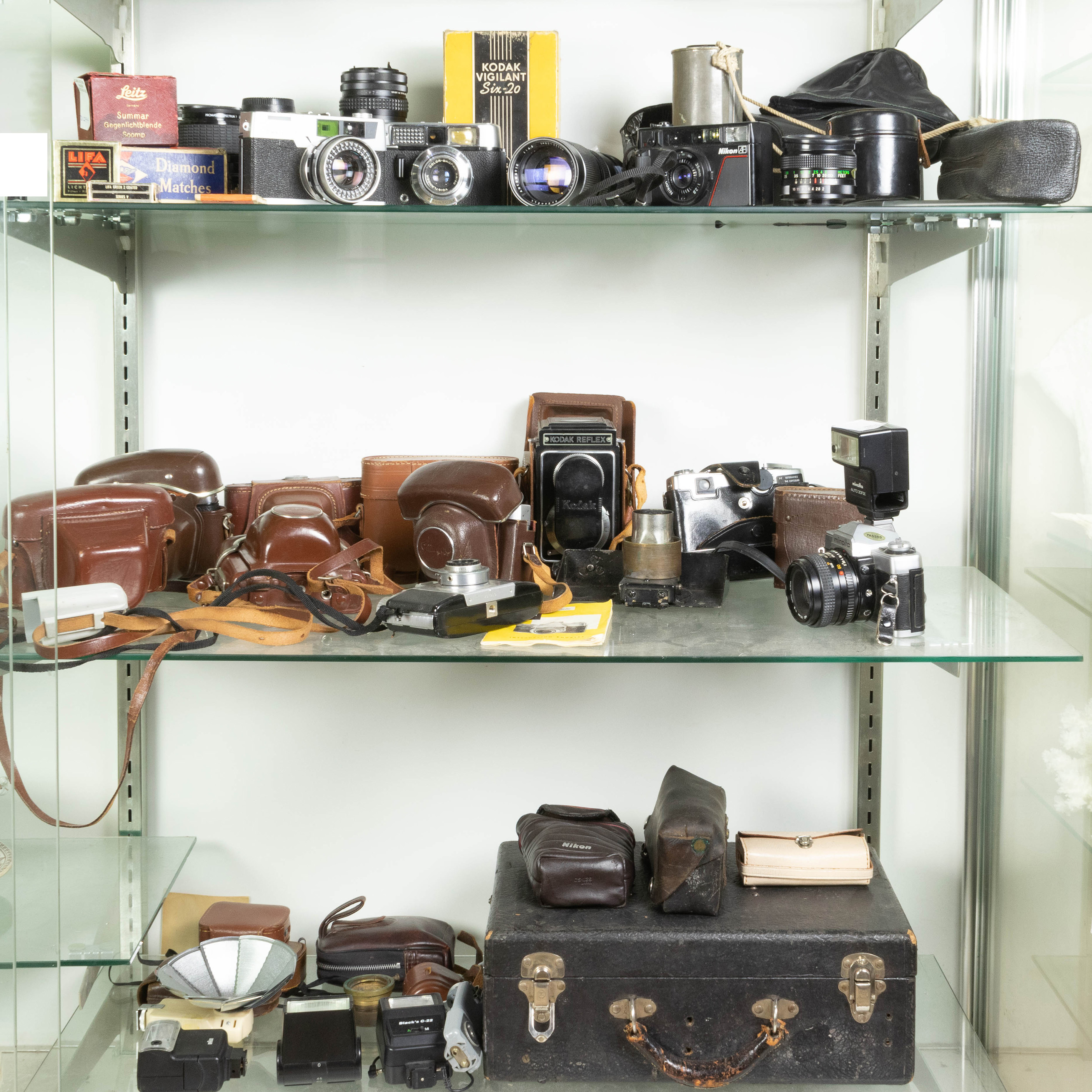 THREE SHELVES OF VINTAGE CAMERAS