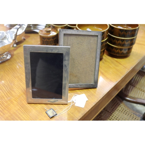 Three silver photo frames, one