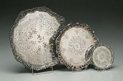 Three silver trays: round