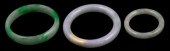 THREE SMALL JADEITE BANGLES in