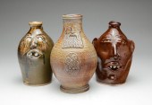 THREE STONEWARE MOLDED JUGS. T