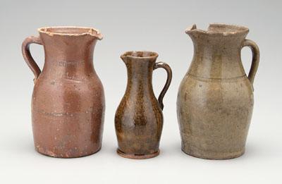 Three stoneware pitchers: one