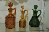 THREE STOPPERED COLORED GLASS
