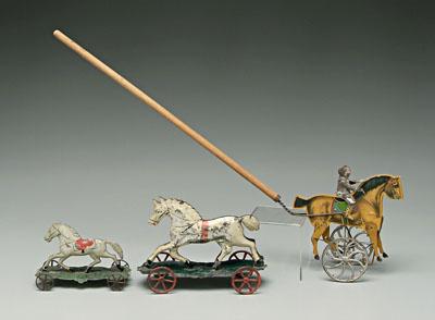 Three tin horse toys: two white