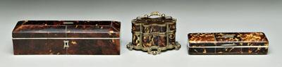 Three tortoise cases: one pen case,