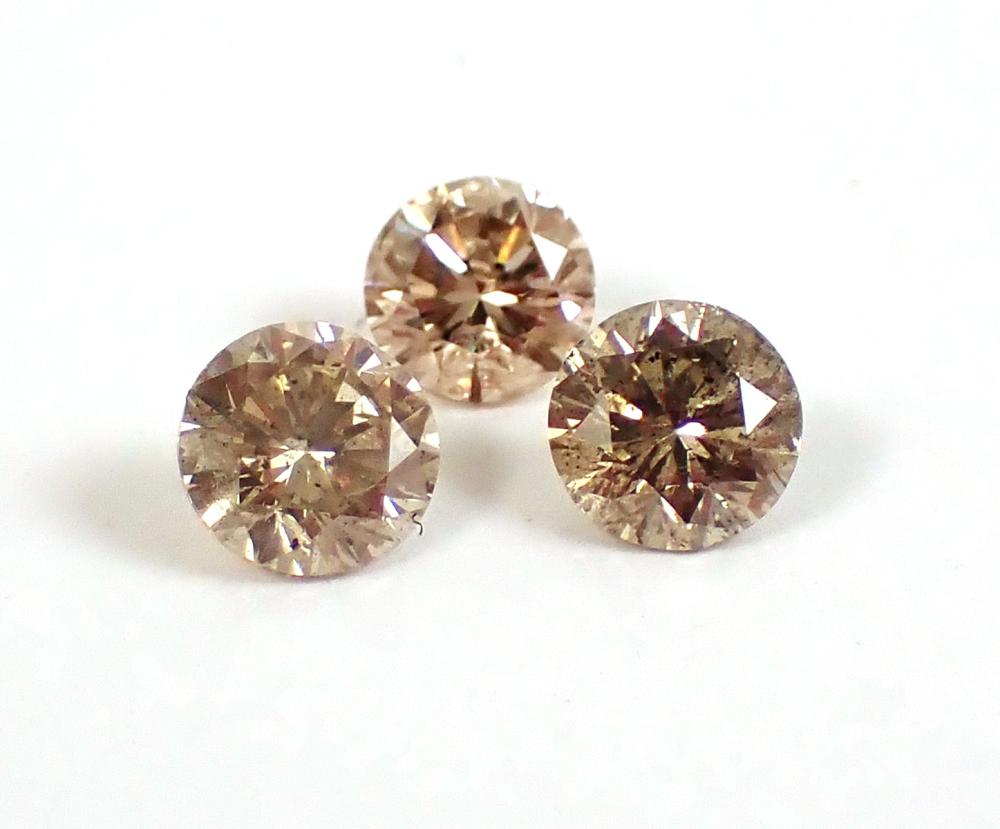 THREE UNSET CHAMPAGNE DIAMONDS, ALL