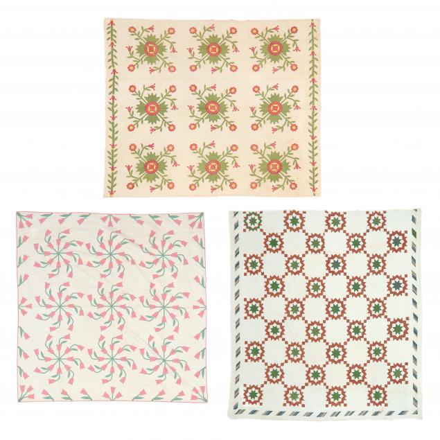 THREE VINTAGE QUILTS The first with