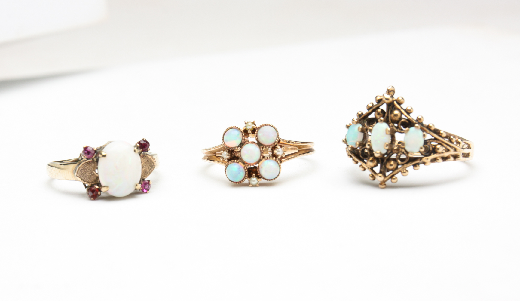 THREE VINTAGE YELLOW GOLD OPAL