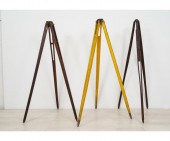 Three wood transit tripods, on