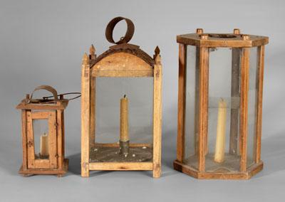 Three wooden lanterns: one with