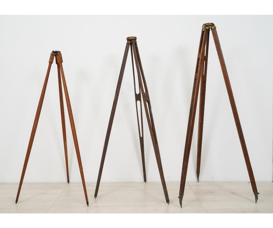 Three wooden transit tripods the
