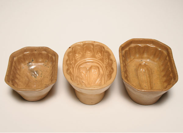 Three yellow ware gelatin molds;