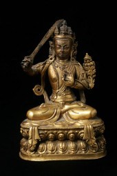 TIBETO-CHINESE GILT BRONZE FIG