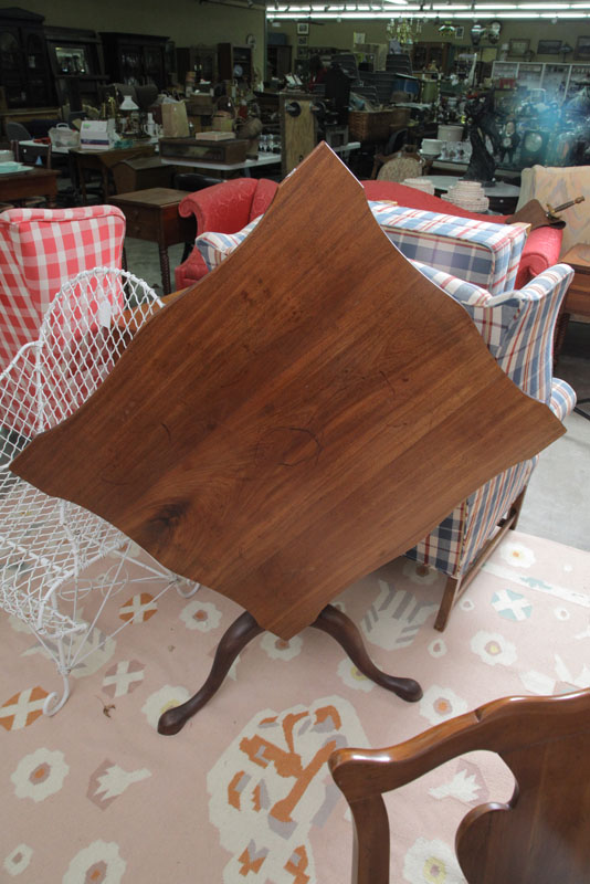 TILT TOP TEA TABLE. Walnut having a