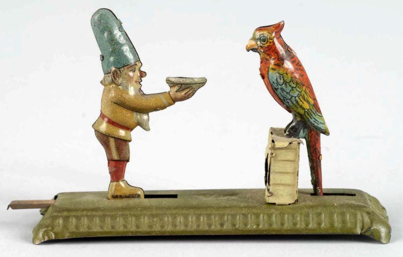 Tin Litho Gnome & Parrot Penny Toy.